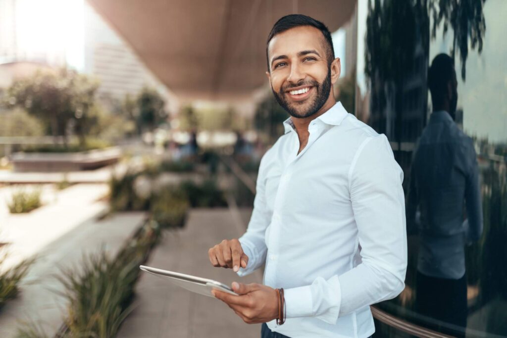 Man Smiling Holding iPad